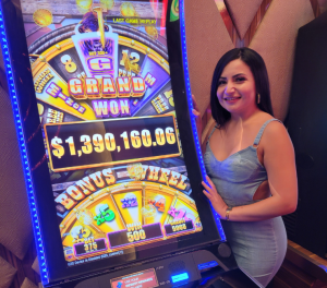 Jackpot winner standing next to winning slot machine