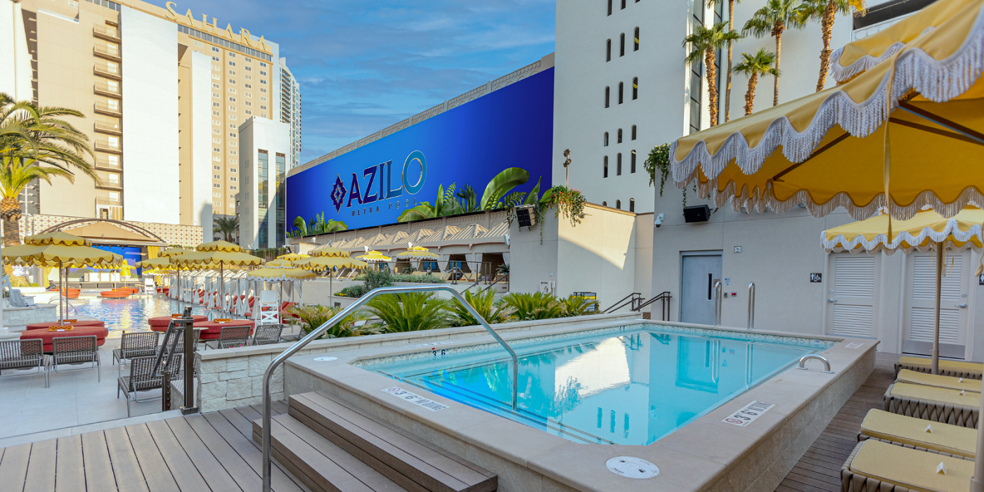 Image of Azilo Ultra Pool overlooking a mini pool in the foreground and the main pool in the background with big giant screens