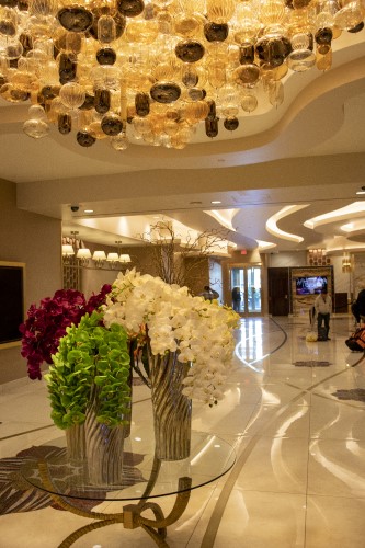 Image of hotel lobby with beautiful floral decor and breathtaking chandelier
