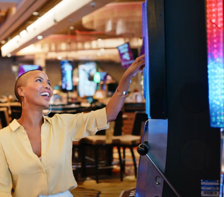 Woman playing slot machine at SAHARA Las Vegas