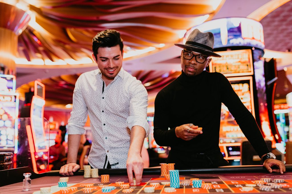 two guys playing casino table games.