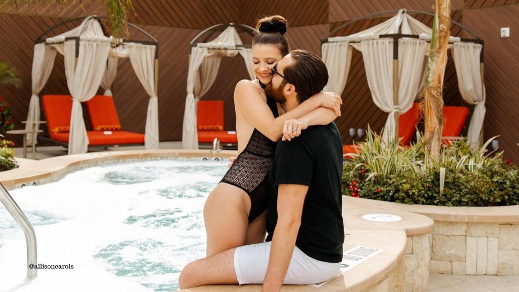 Allison Carols with a man hugging poolside at AZILO ULTRA POOL