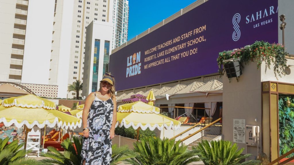 the principal of a local elementary school standing infront of the large AZILO Ultra Pool screen