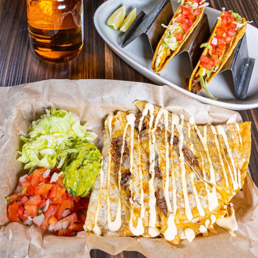quesadilla and tacos with guacamole and salsa from uno mas