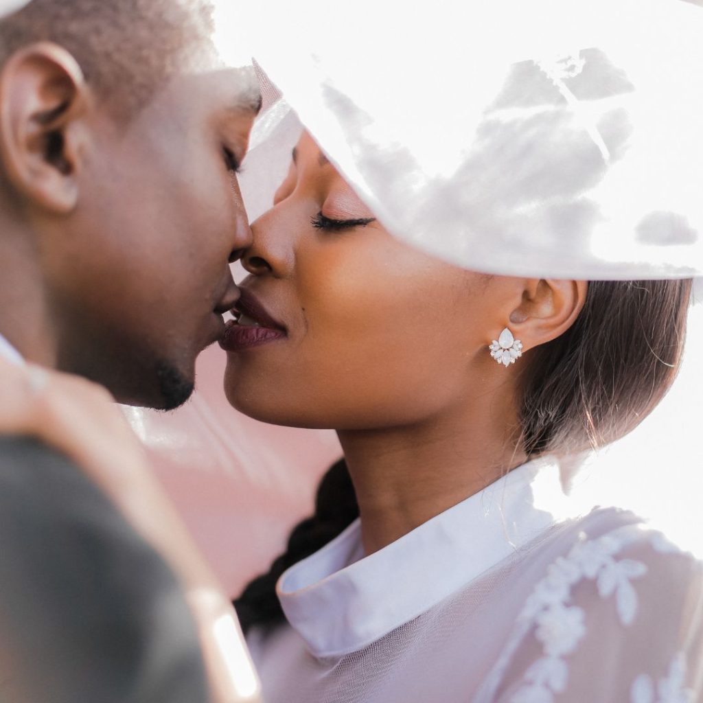 A couple starting to kiss in a wedding environment