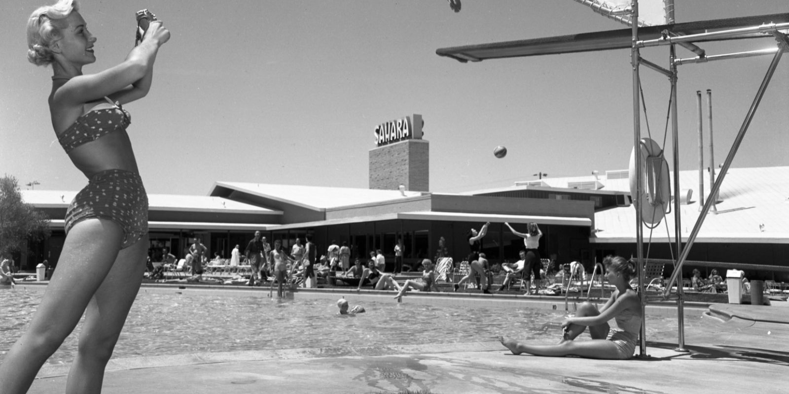Vintage SAHARA Las Vegas image of people at the resort pool. The image is in black and white