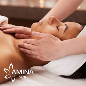 A woman getting a facial at amina spa. she is laying down with her eyes closed.