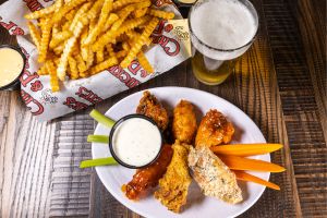 National Chicken Wing Day at Chickie's & Pete's - picture of  different sauced wings served with ranch and fries.