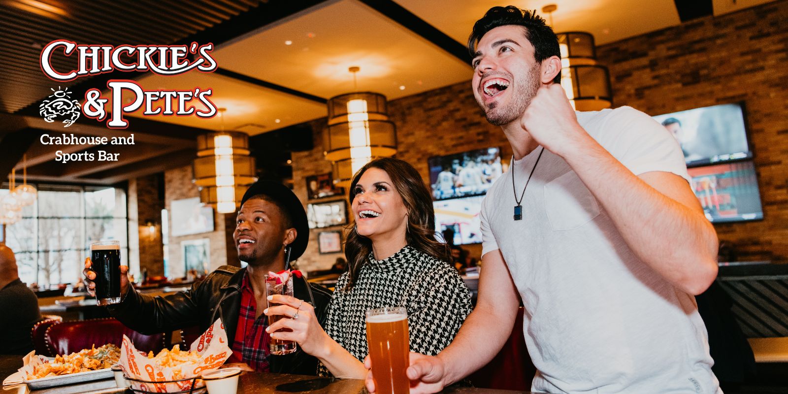 chickie's & Pete's sports bar shot showing people cheering for a team