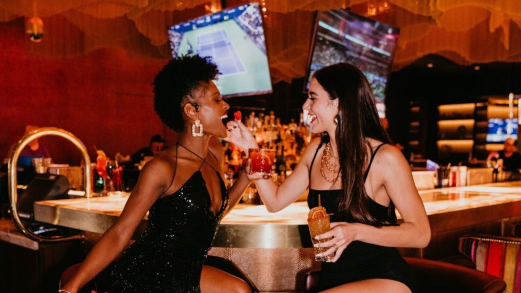 Two girls playing with drinks at CASBAR Lounge