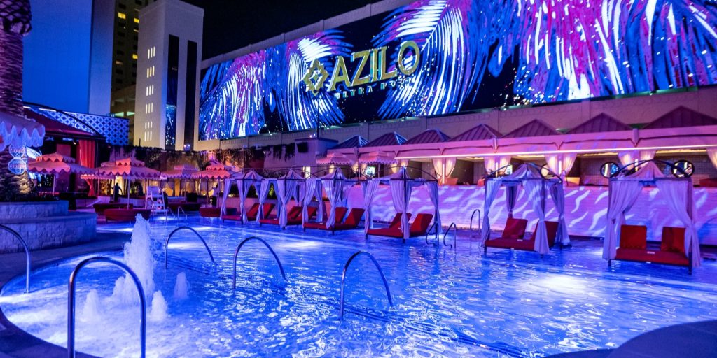 night time shot of AZILO ultra pool with large LED video wall as feature