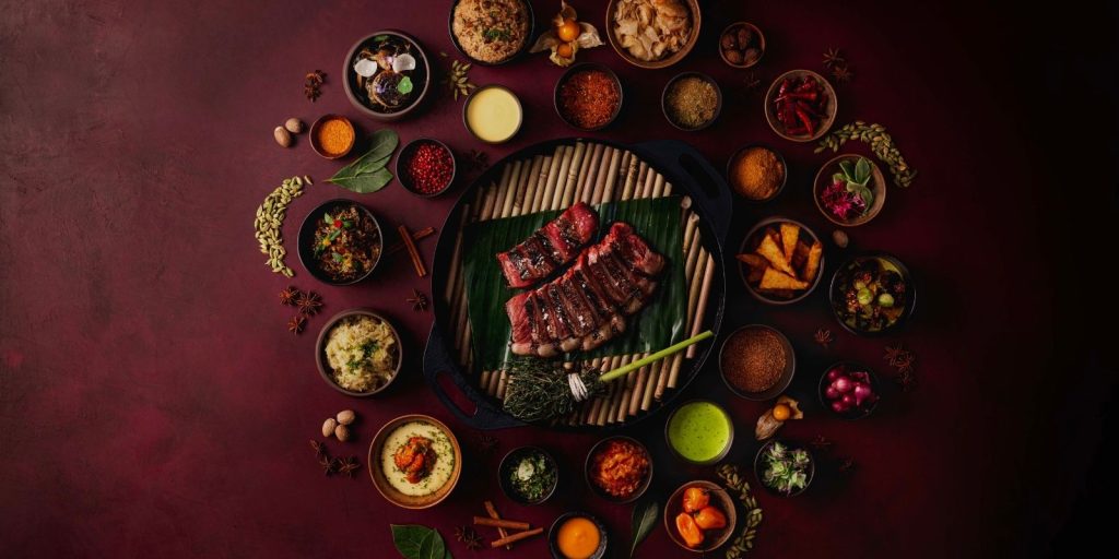 a picture of Maroon cut beef with spices and sides around it