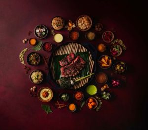 a picture of Maroon cut beef with spices and sides around it